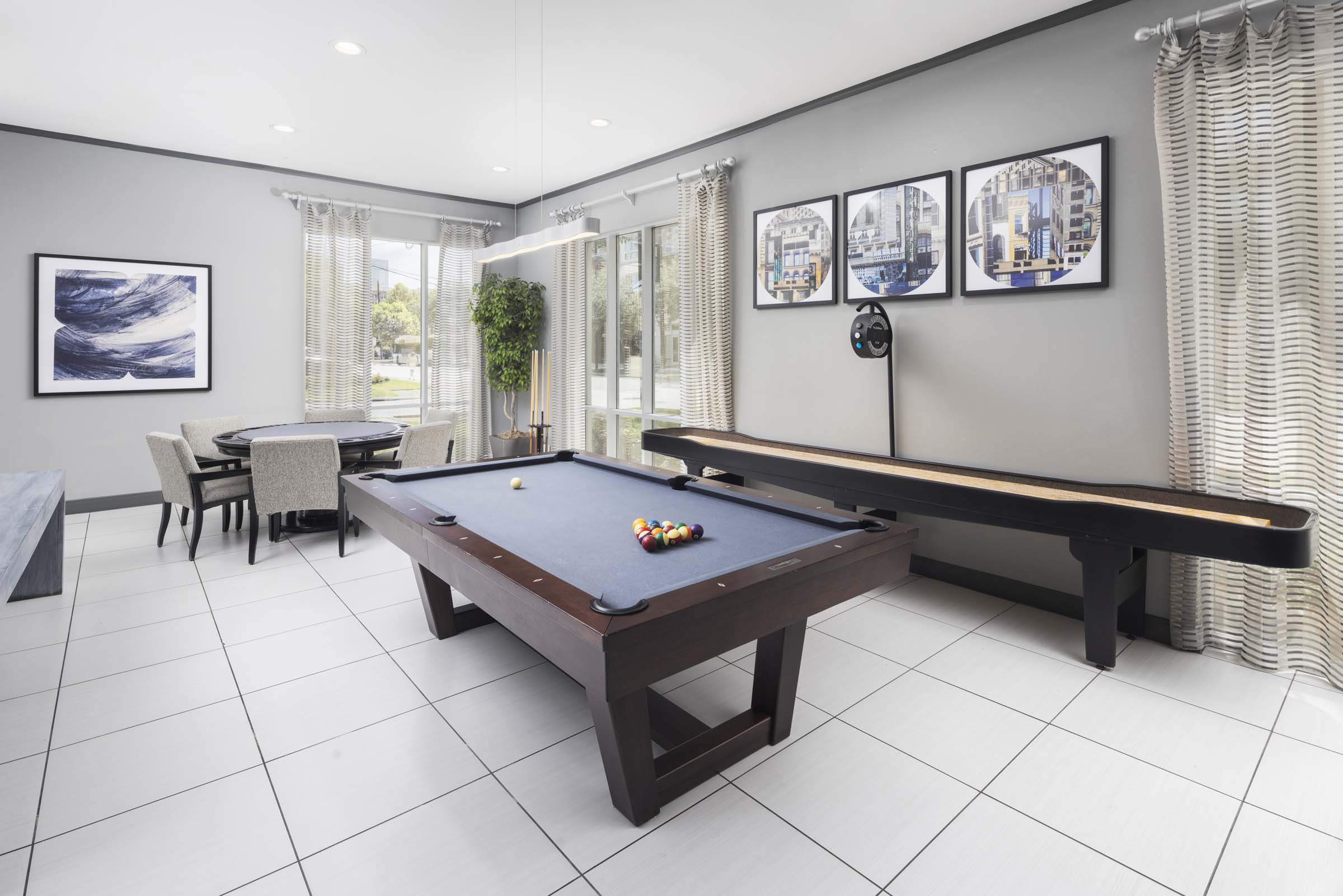 Game room with billiards and shuffleboard at Camden Travis Street Apartments in Midtown Houston, TX