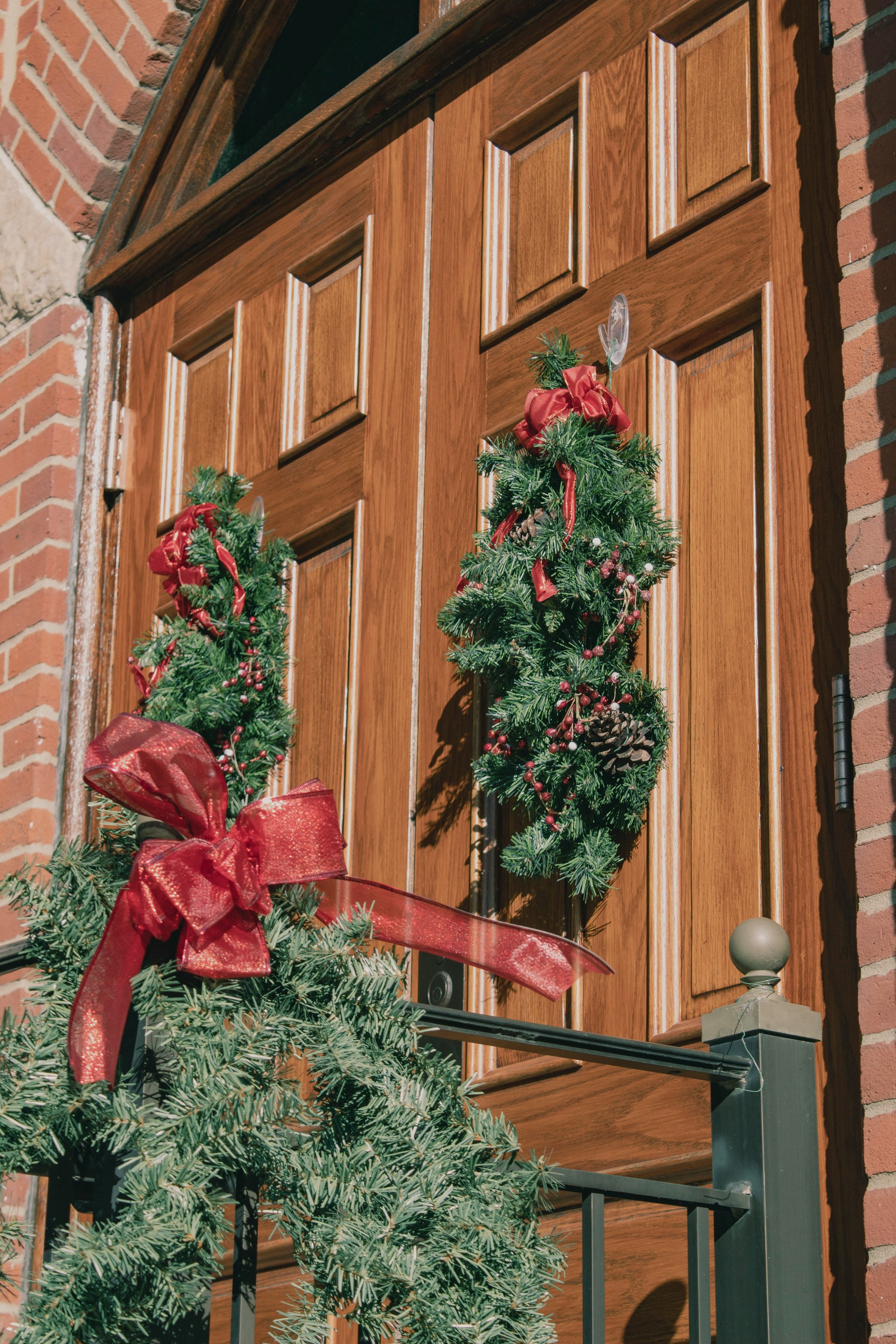 https://unsplash.com/photos/a-pair-of-wreaths-on-the-front-door-of-a-building-MpwBSYrbTzY