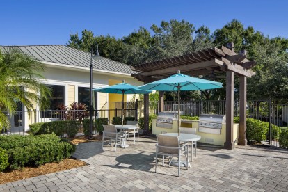 Pool deck with grills and picnic tables