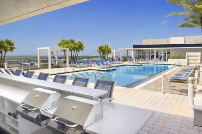 Outdoor oasis in the sky with BBQ grills at Camden Pier District apartments in St. Petersburg, Florida.