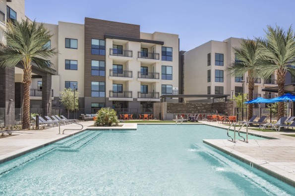 Camden Tempe West Apartments in Tempe Arizona west pool amenity with sun deck and loungers near barbecue grill and corn hole