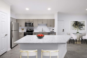 Stainless steel appliances and white quartz kitchen island at Camden Landmark Apartments in Ontario CA