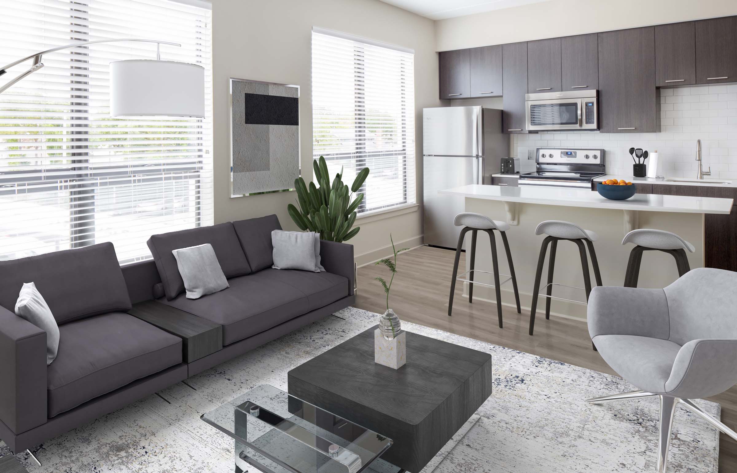 Open-concept living room and kitchen in studio floor plan at Camden North Quarter apartments in Orlando, FL