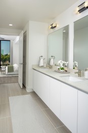 Penthouse bathroom with white quartz countertops, white, soft-close cabinetry, and tile flooring