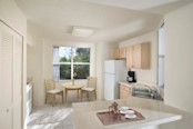 Light cabinetry, white appliances and laminate countertops in the apartment kitchen at Camden Plantation in Plantation, FL.