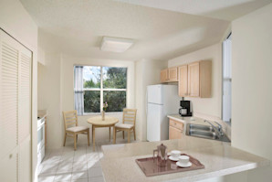 Light cabinetry, white appliances and laminate countertops in the apartment kitchen at Camden Plantation in Plantation, FL.