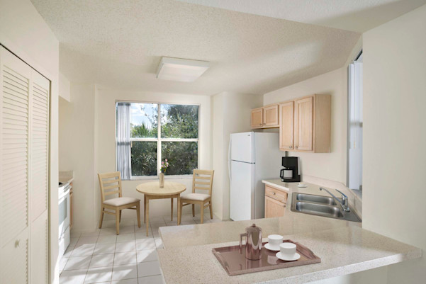 Light cabinetry, white appliances and laminate countertops in the apartment kitchen at Camden Plantation in Plantation, FL.
