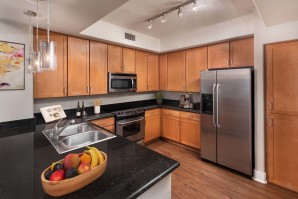 Kitchen with black granite countertops and stainless steel appliances