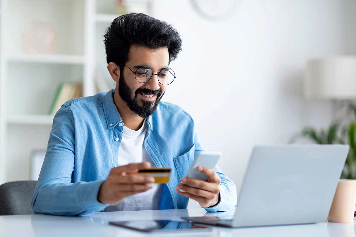 Man makes payment on mobile phone at home