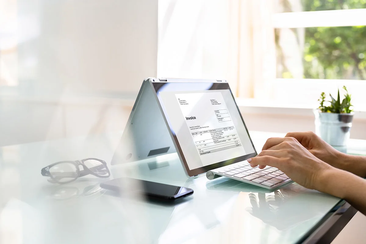 Closeup of sending an invoice from a laptop