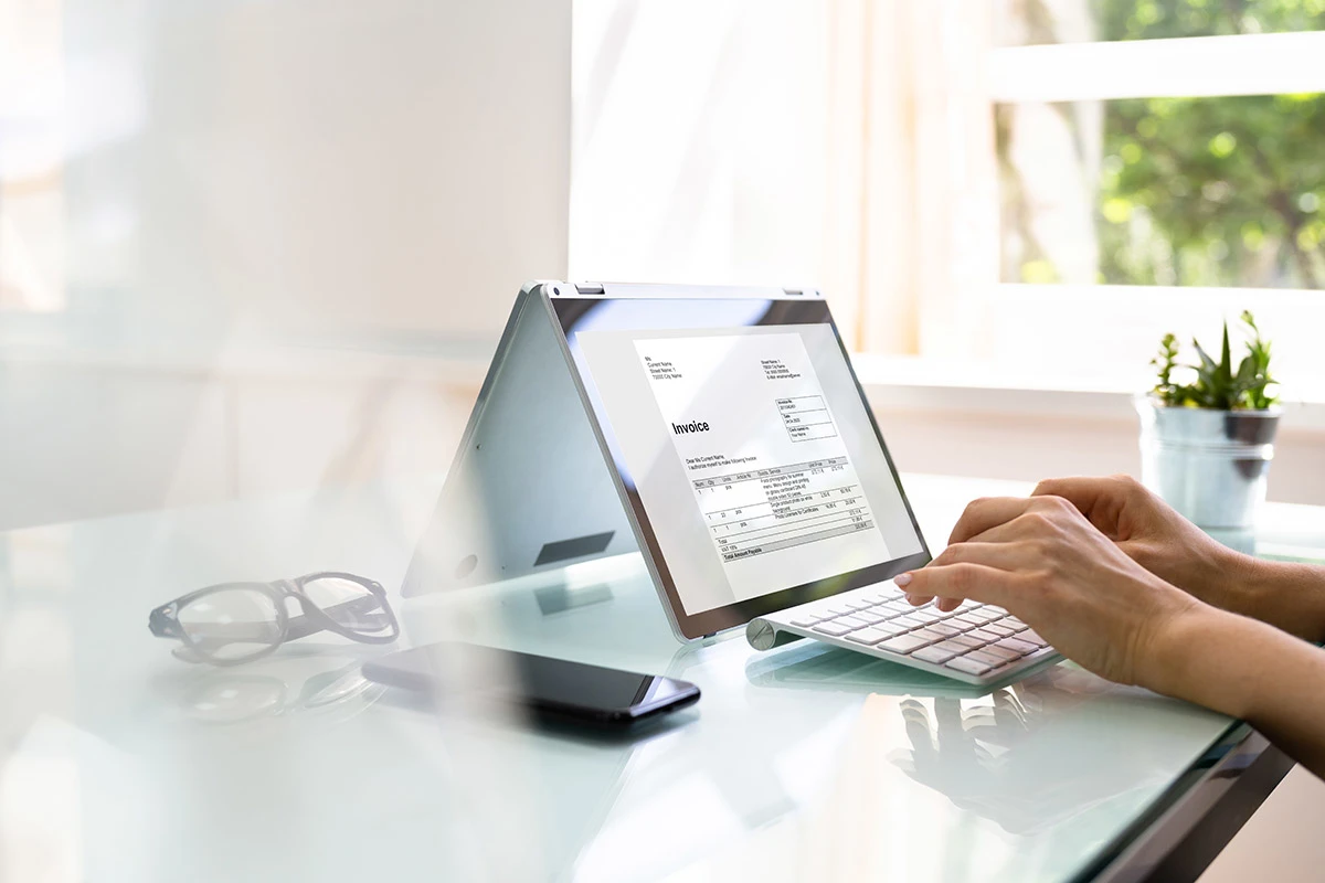 Closeup of sending an invoice from a laptop