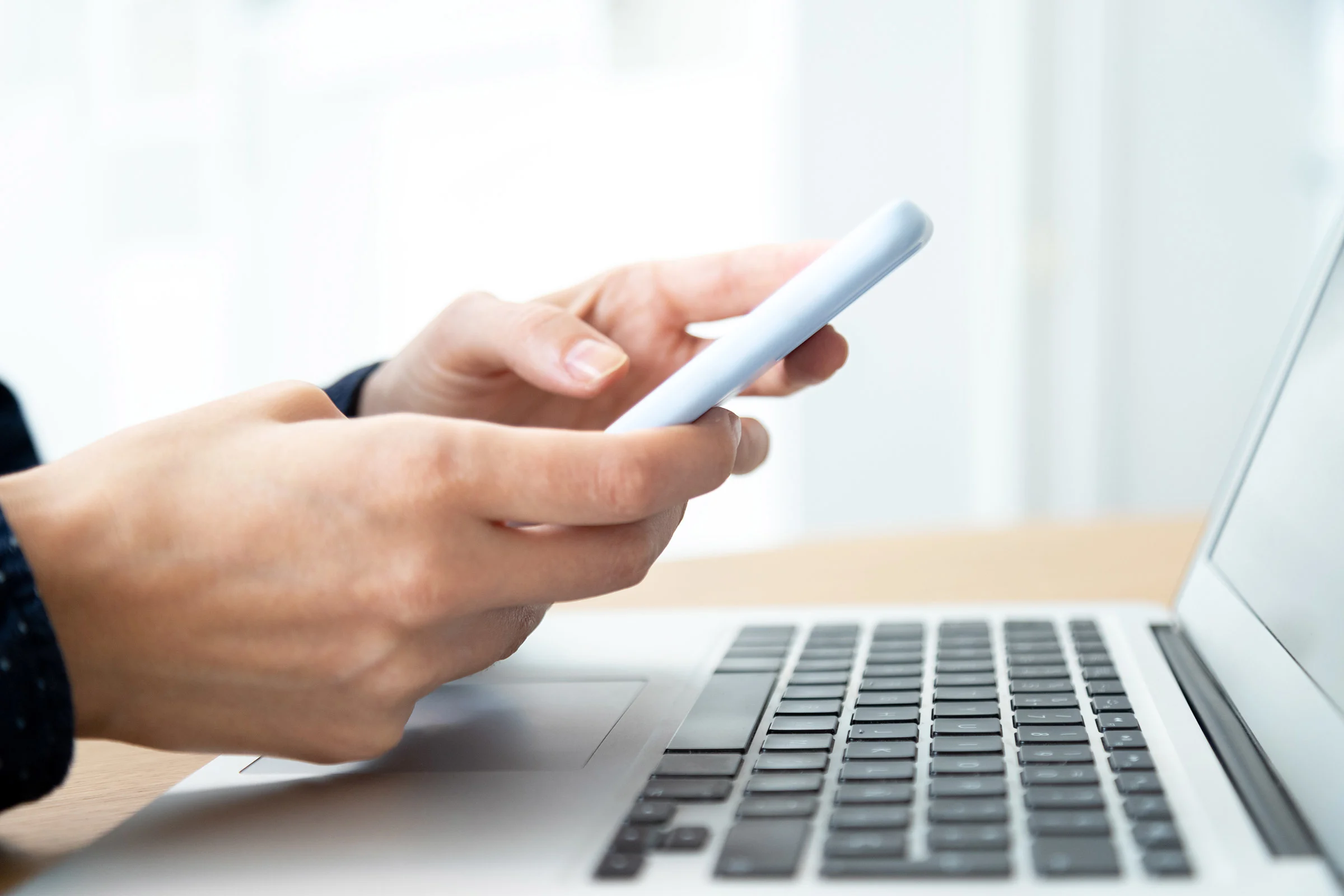 Close-up of woman's hands checking SMS messages on her phone