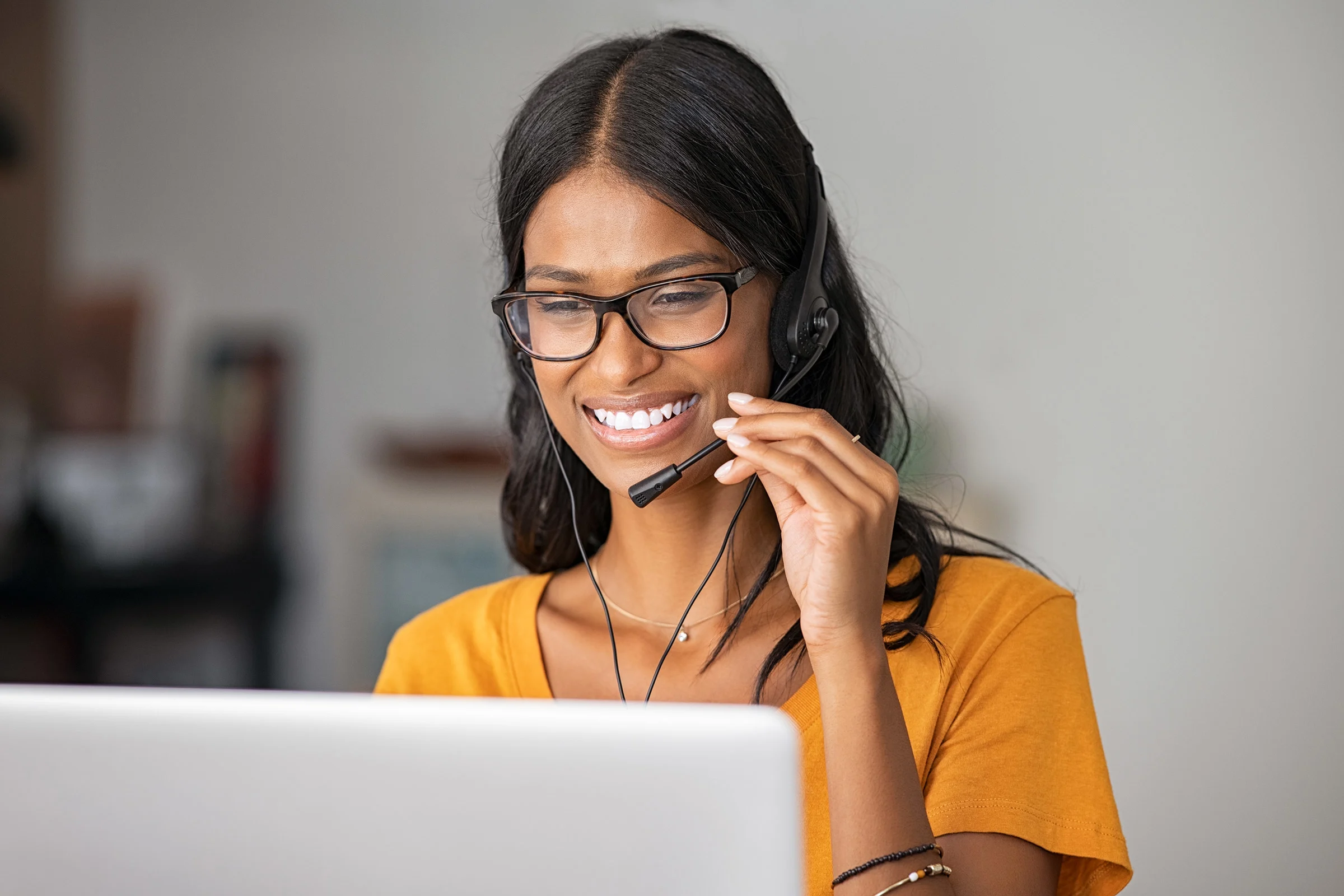 Happy Indian woman working in a call center