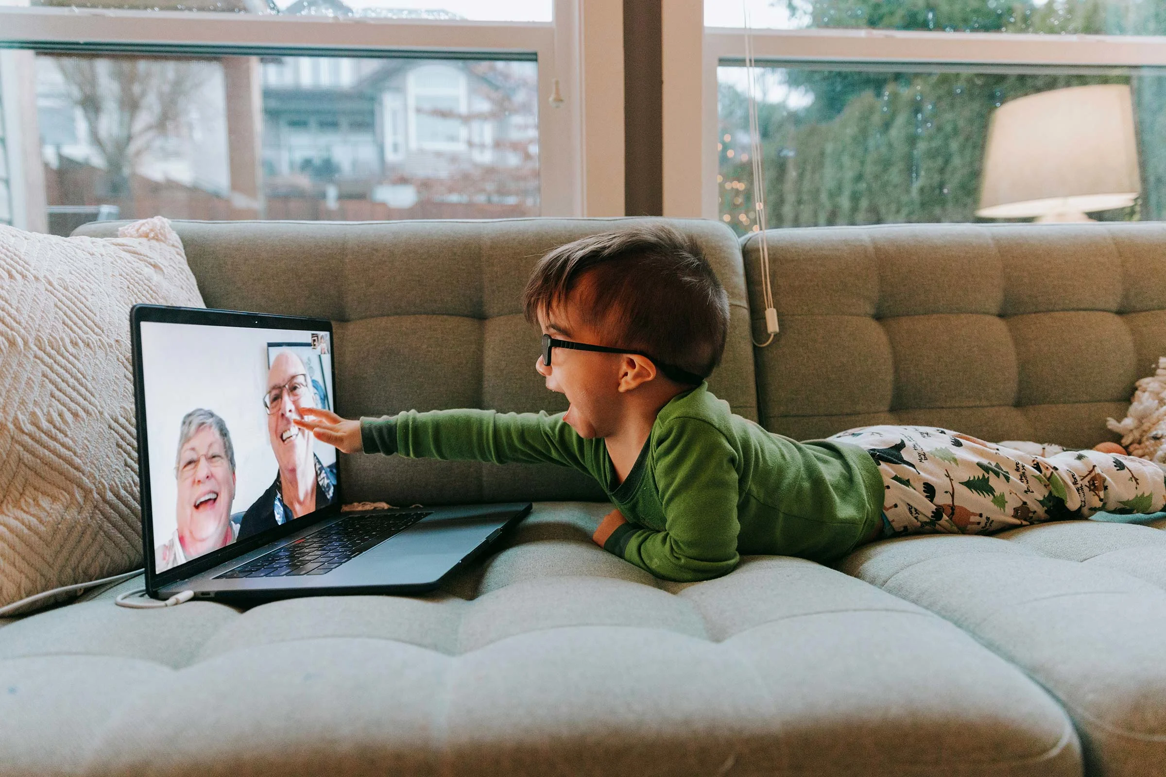 Little boy video chatting with his grandparents