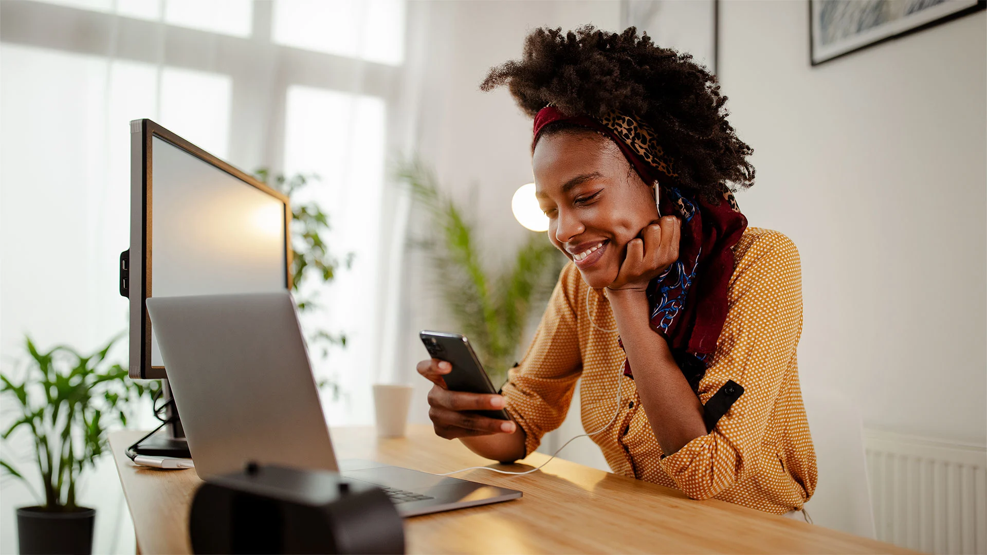 Happy young student listening to music and doing work