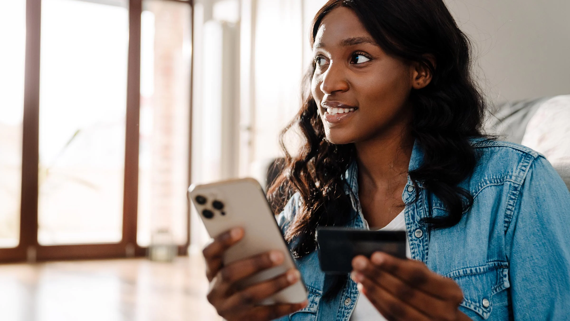 Young woman using phone to make online payment