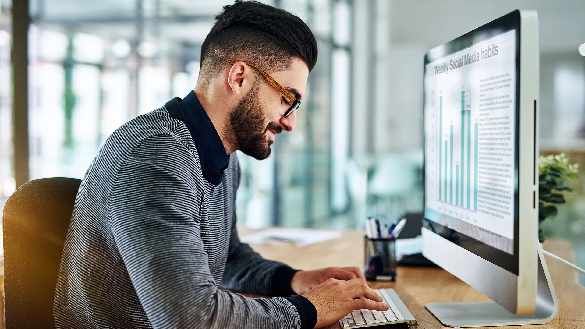 man typing on desktop