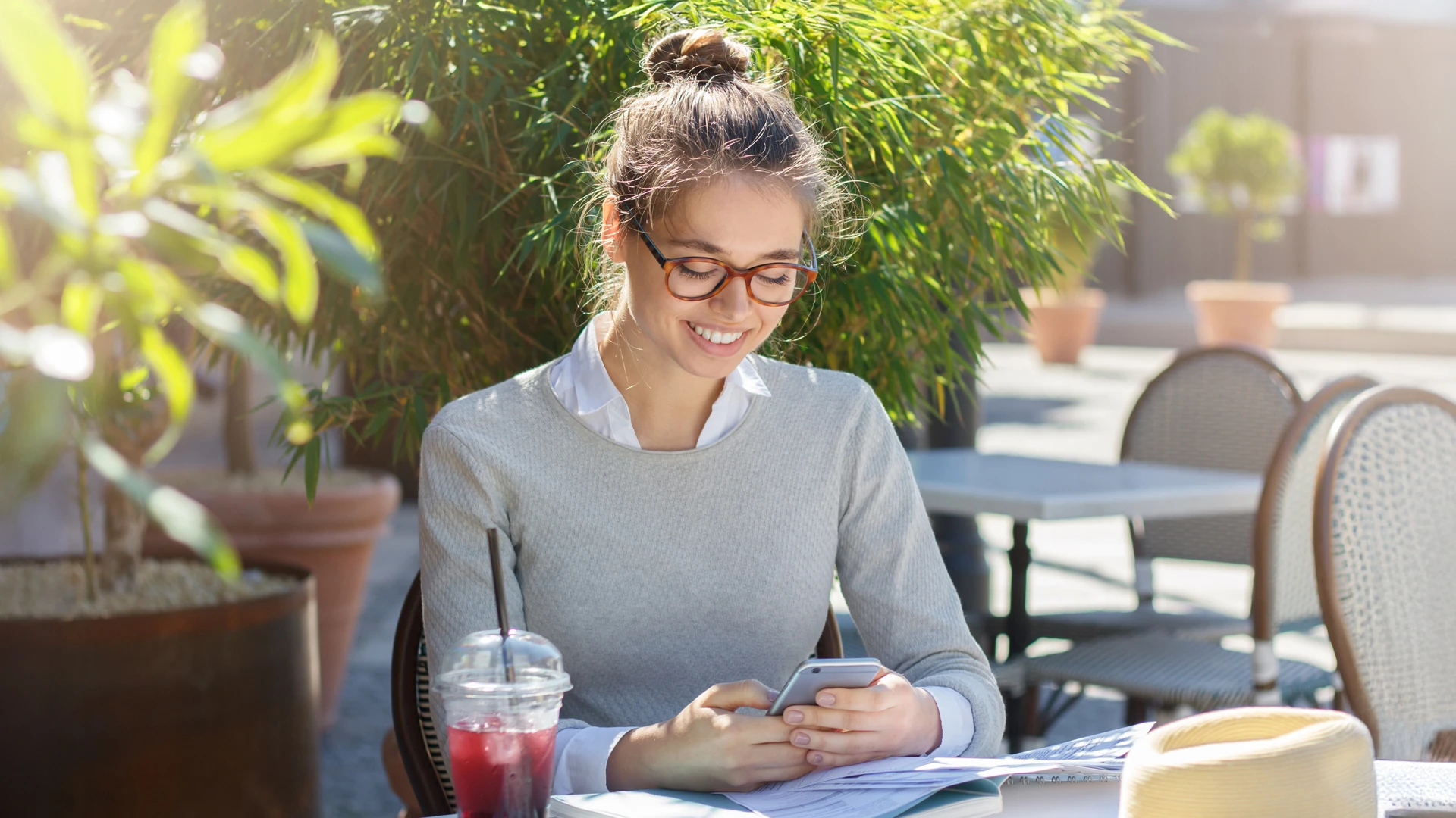 girl using phone outside at coffee shop