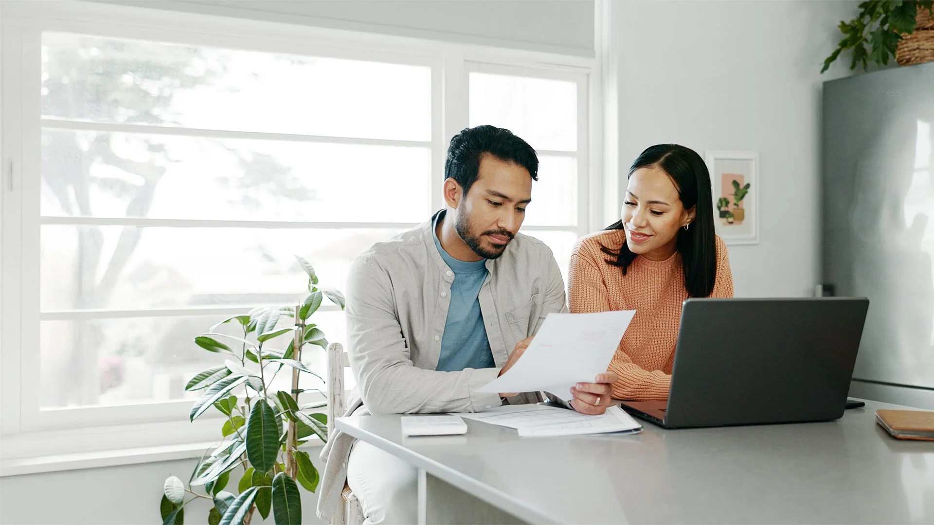 Couple paying bills together in the kitchen