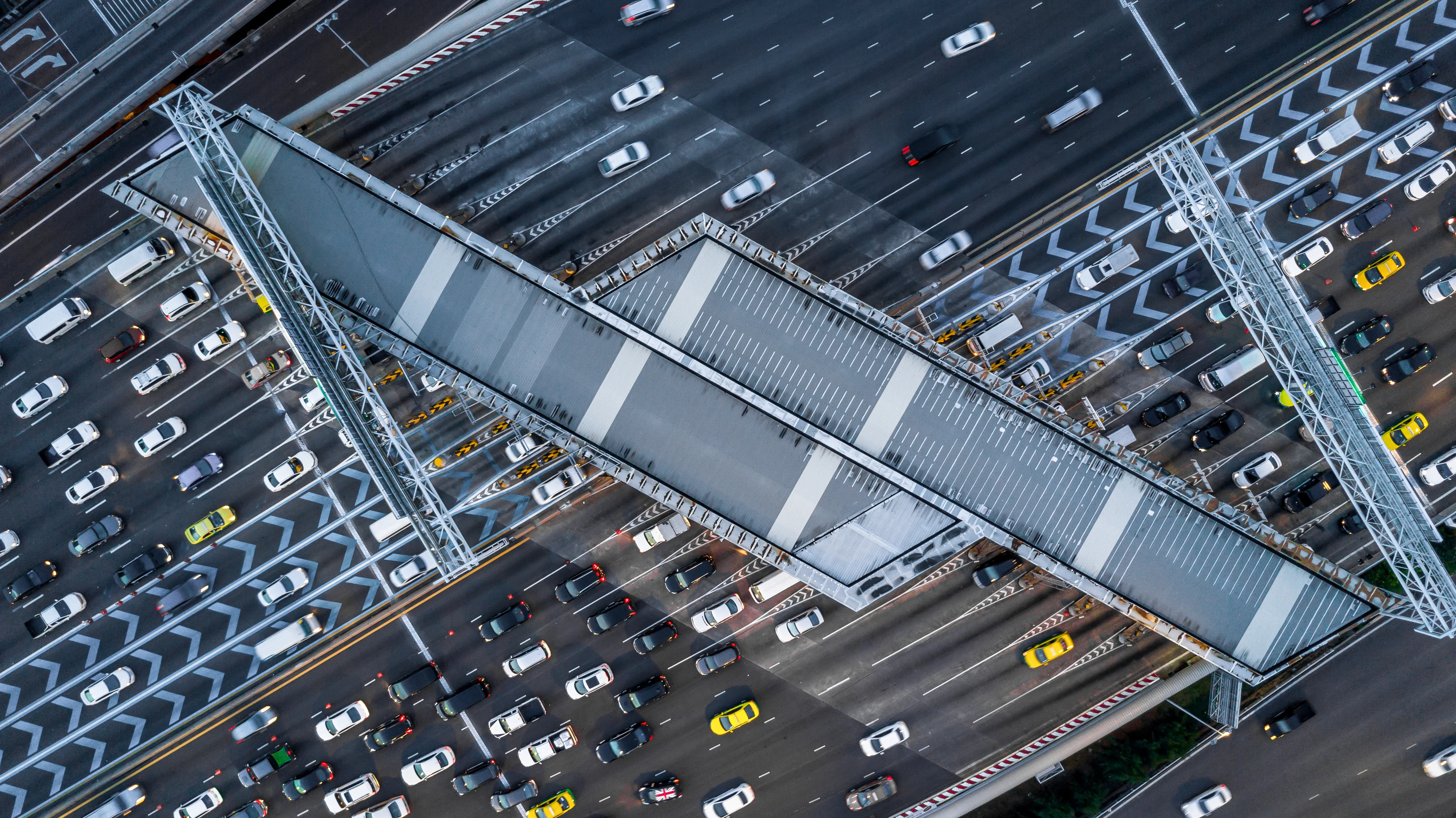 Aerial view cars waiting to pay at the expressway, Gate for expressway fee payment, Cars at gate for expressway fee payment, traffic jam with row of cars on expressway during rush hour.