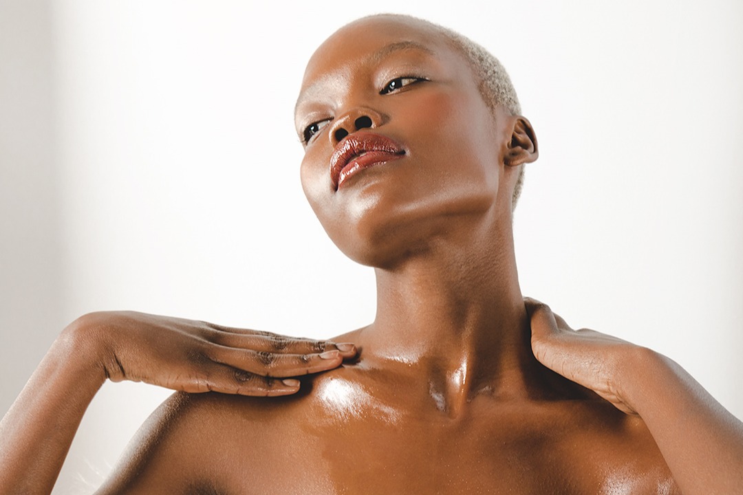 NUXEHuileProdigieuseMultiPurposeDryOil - woman applying body oil to her collar bones and chest - 1080 x 720