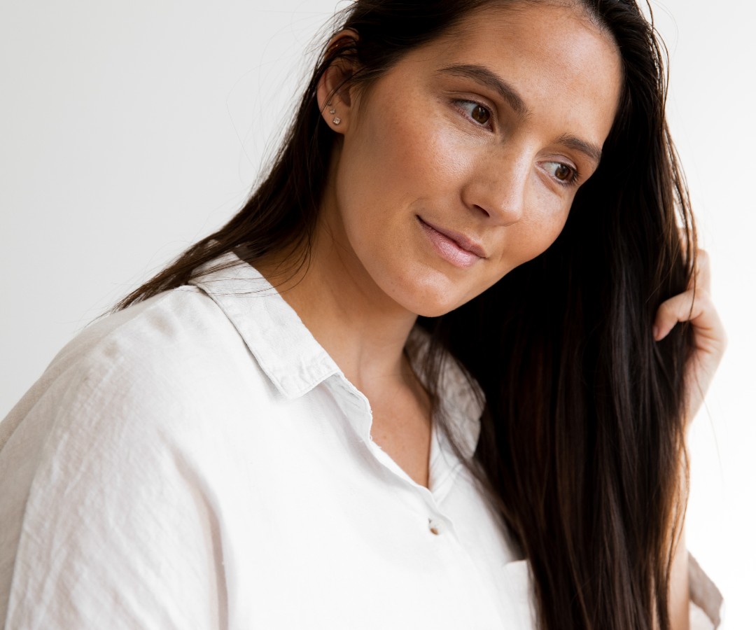 Fixing Damaged Hair Is Keratin Right for You?_a woman with long dark hair in a white shirt_1080x900