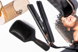 What’s the Difference Between GHD and Cloud Nine? - flat lay of cloud nine brush and straightener next bag, magazine, glass jar and gold earrings - 650 x 433