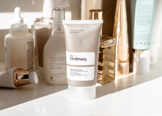 The Ordinary Squalane Cleanser  - product bottle displayed in front of various perfume and skincare bottle - 1080 x 771