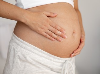 best-stretch-mark-creams_woman holding pregnant belly_1080x800