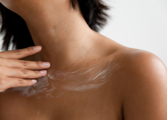 Adore Beauty - anti-aging neck and chest creams - close up of decolletage with hand applying neck cream across collar bones - 1200 x 800