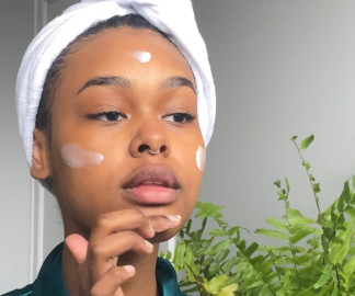 How Often Should You Moisturise Your Face? - model with hair up in white towel applying moisturiser to her face