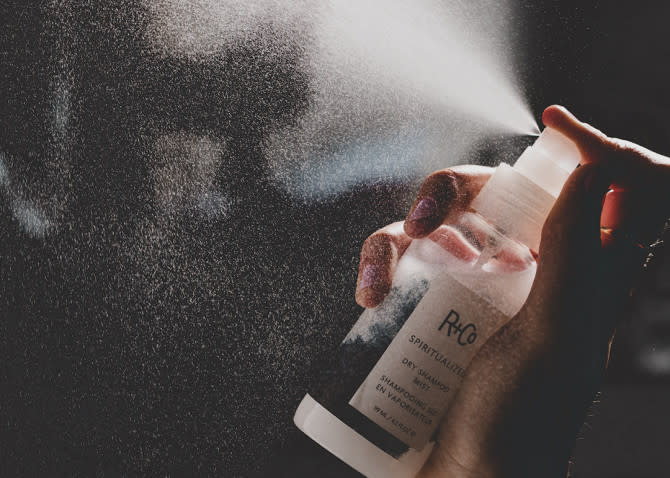 R+Co Spiritualized Dry Shampoo Mist - hand spraying mist bottle into air - 670 x 478