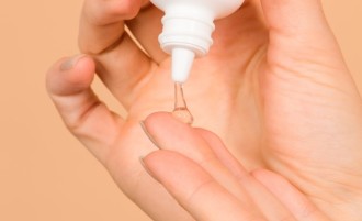 Dermalogica Overnight Clearing Gel  - hand squeezes small amount of clear gel out of product bottle onto fingertip - 670 x 408