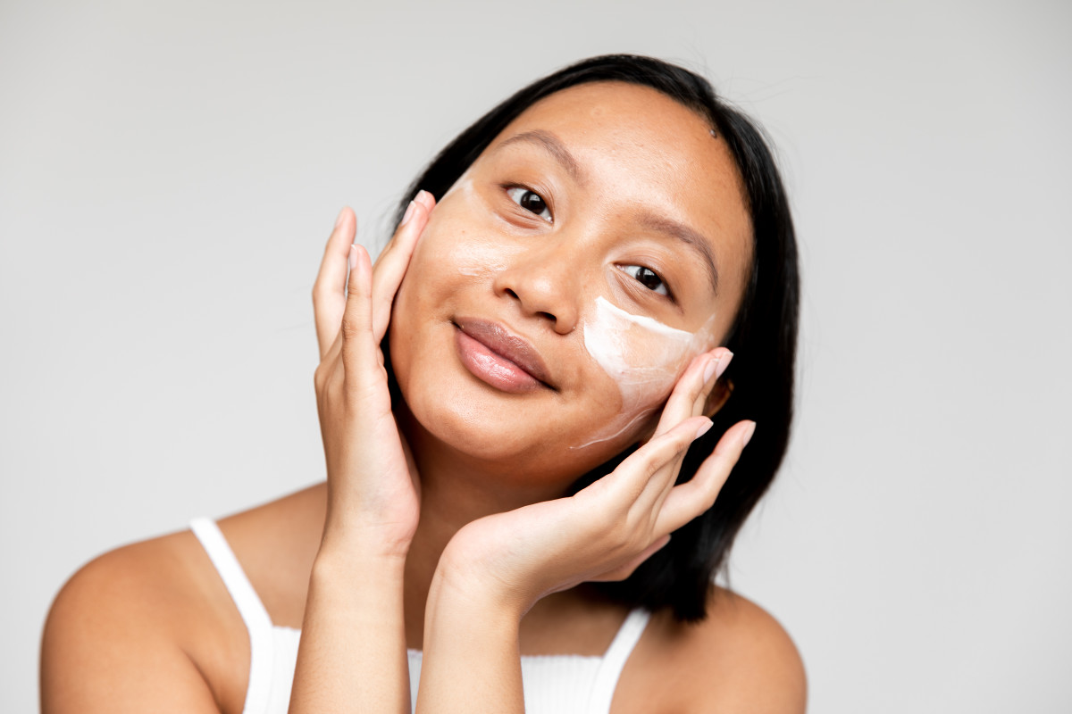 Adore Beauty_skin-care_woman applies skincare to her face using her fingertips - 1200 x 800