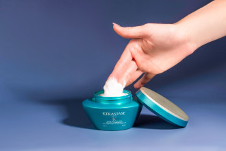 Kerastase Masque Therapiste  - a hand is dipping into product tub coating fingertips in hair mask - 