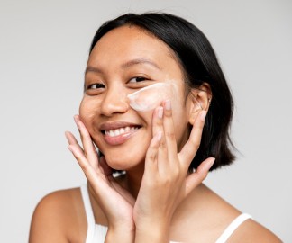 But Seriously, Do I Really Need a Cleanser?_model with short dark hair is applying a cream cleanser to her face