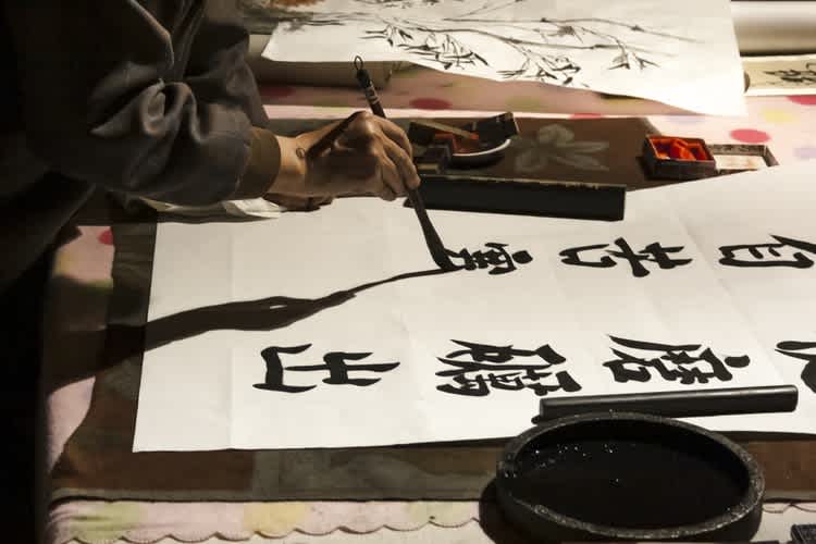 Old men painting Chinese characters on paper rice
Marco Zuppone via Unsplash