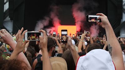 People in the audience using smartphones to record Kanye West performing on the Main Stage at the Wireless Festival in Finsbury Park, north London.