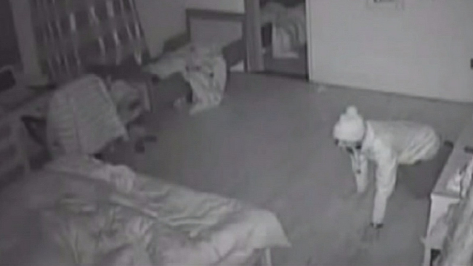 Armed burglar caught on camera crawling into sleeping couple's bedroom ...