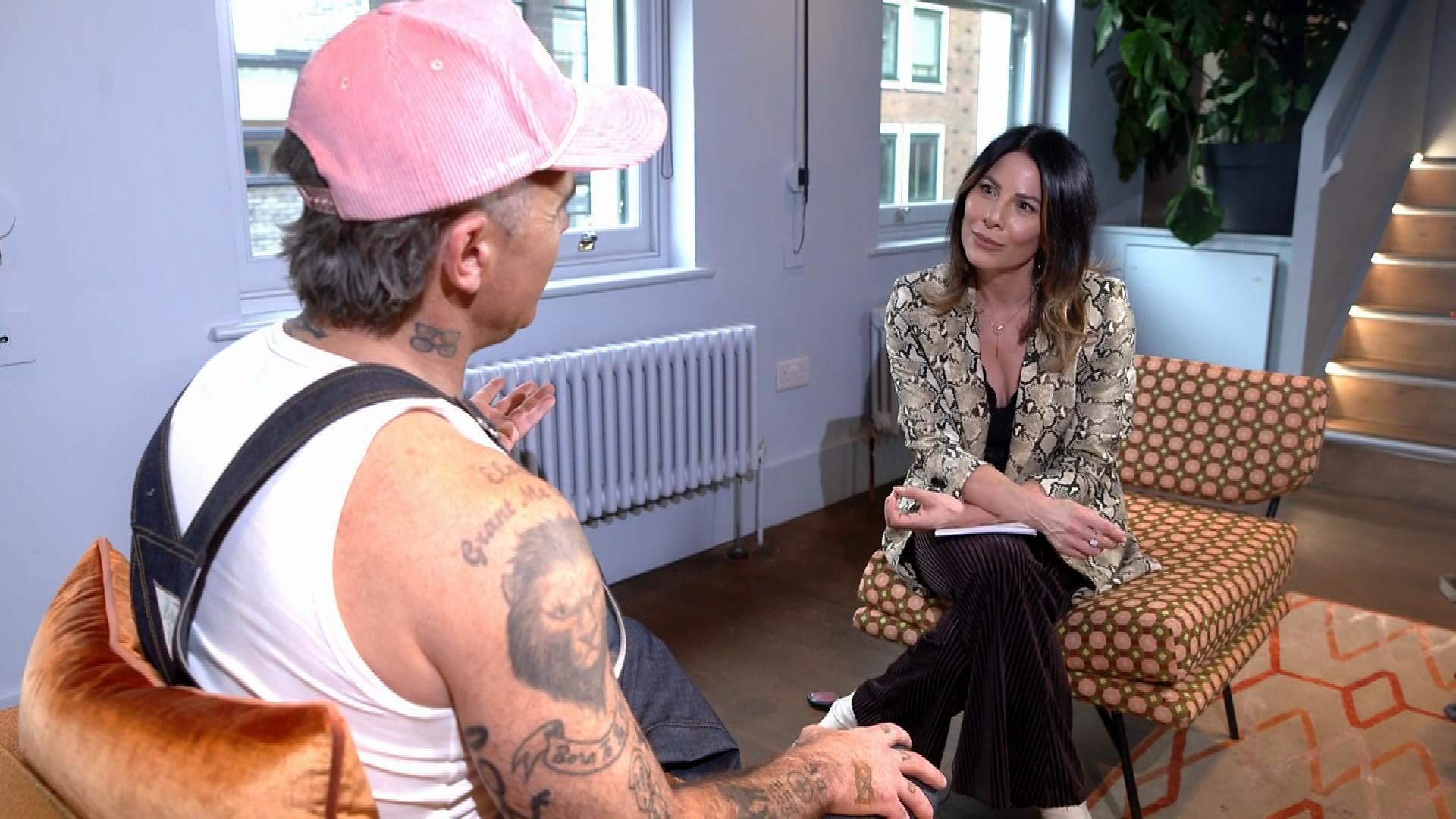 Robbie Williams speaking to ITV News London presenter Lucrezia Millarini