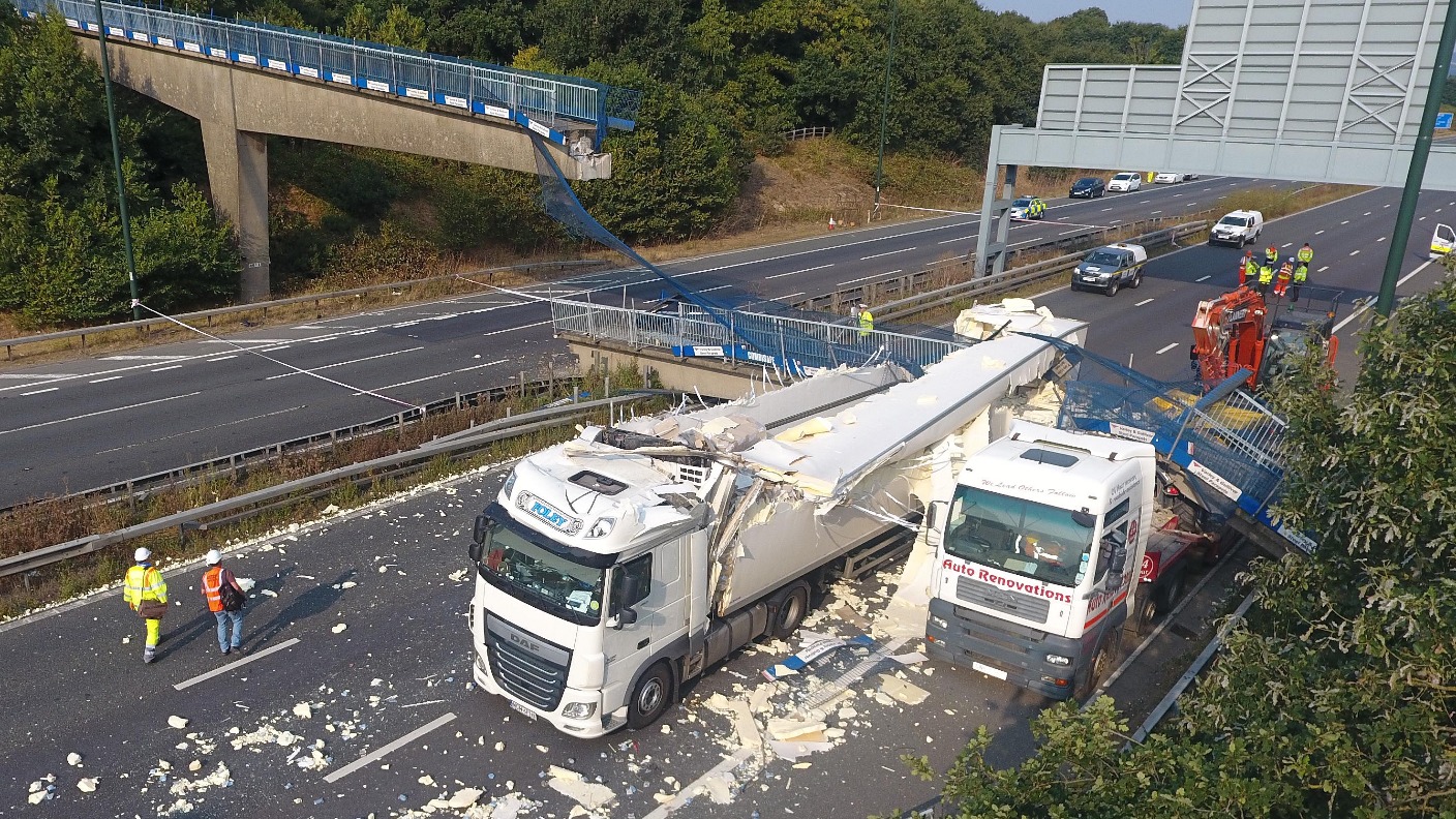 Truck crashing to Bridge. Danger Low Bridges for Trucks. The Truck is Crossing the Bridge. Smashed Truck\.