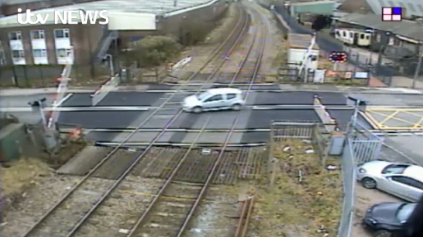 Watch: Driver swerves safety barriers at level crossing | ITV News Central