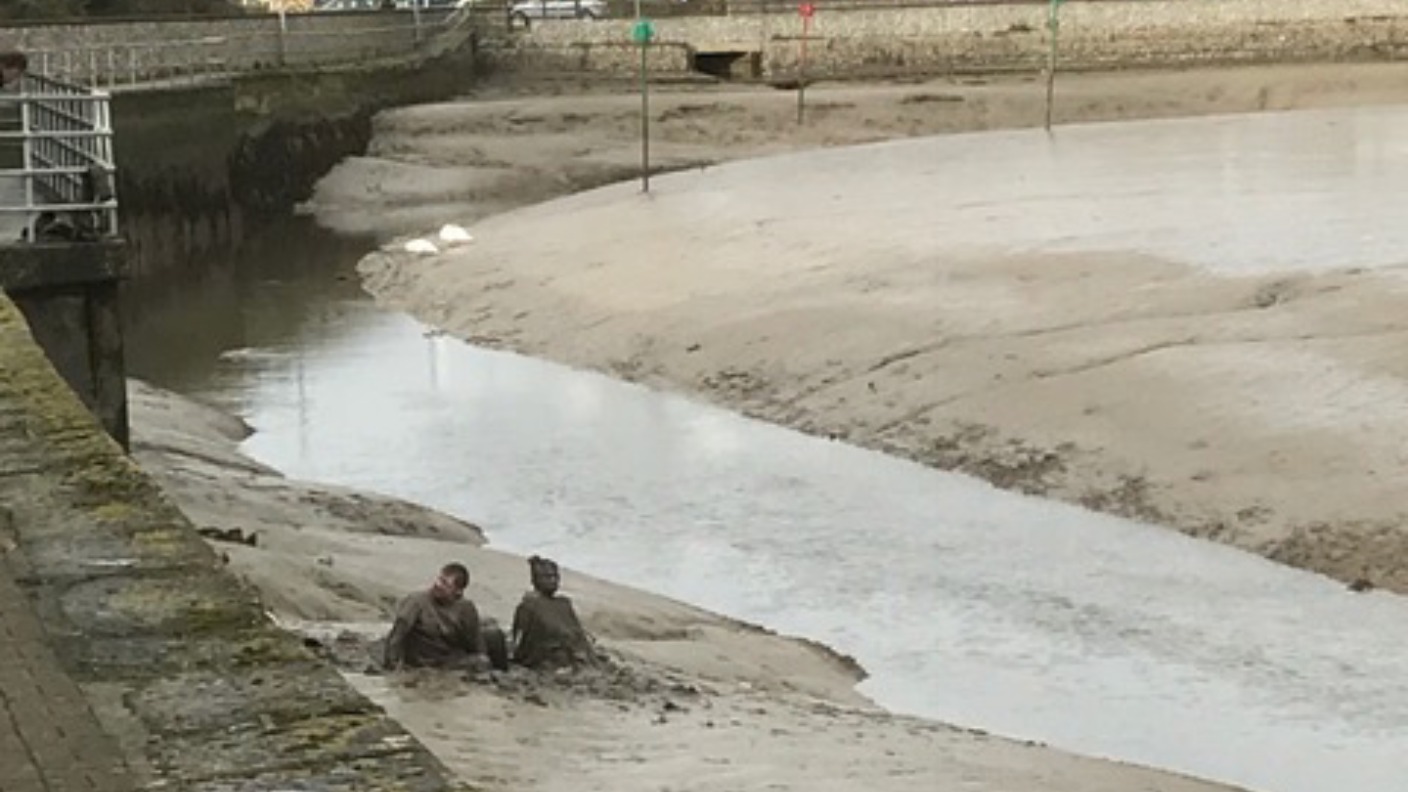 Sticky situation as couple get stuck in the mud after falling into ...