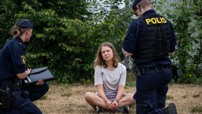 Police officers speak to Greta Thunberg in Malmo, Sweden.