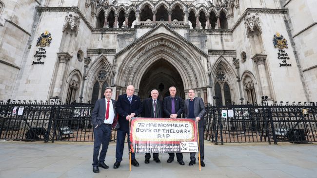Treloars blood infection scandal survivors at the Royal Courts in London.
Des Collins (lawyer ) is the man in the middle holding the document
Gary Webster left
Steve Nicholls second from left
Richard Warwick to the right of Des
Ade Goodyear far right
Credit: Bell Yard 