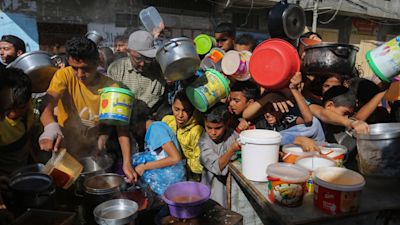 Palestinians gather to collect food at a distribution centre in the Gaza Strip.