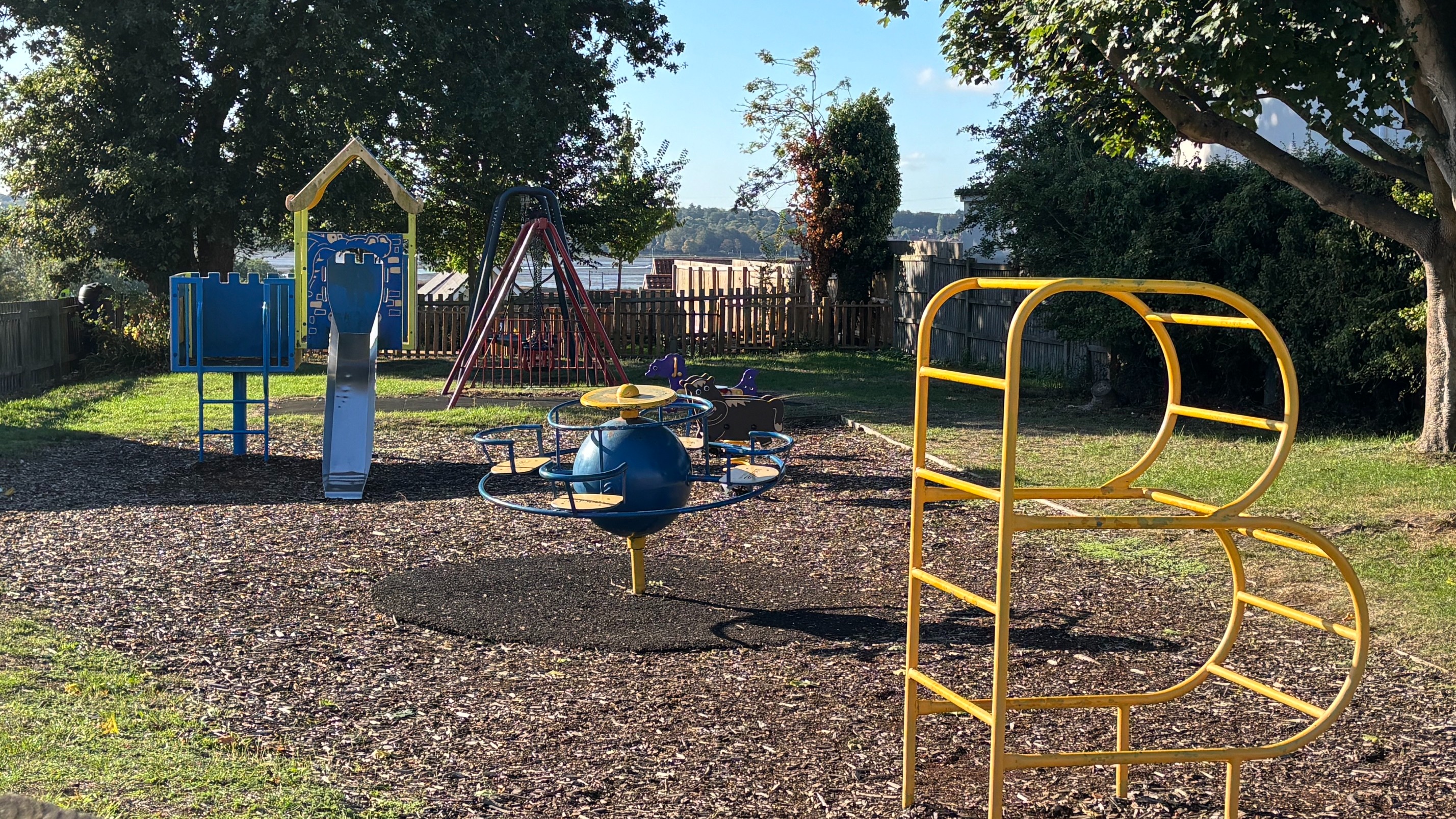 A children's playground with climbing frames and slides.