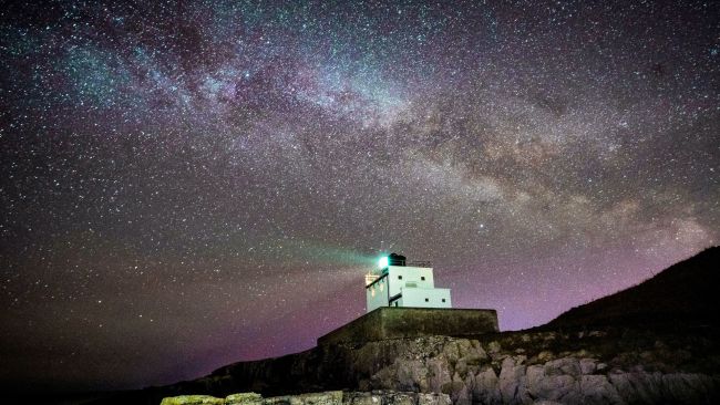 The core of the Milky Way becomes visible in the early hours of Tuesday morning as it moves over Bamburgh Lighthouse at stag Rock in Northumberland. 