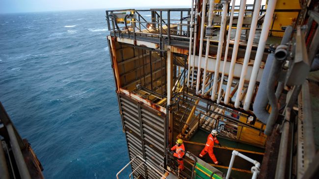 Employees stands on part of the BP Etap platform (Eastern Trough Area Project) in the North Sea, around 100 miles east of Aberdeen, Scotland, as David Cameron visited the oil and gas platform as the focus of the Scottish independence debate shifted to the future of North Sea production.  Andy Buchanan/PA
