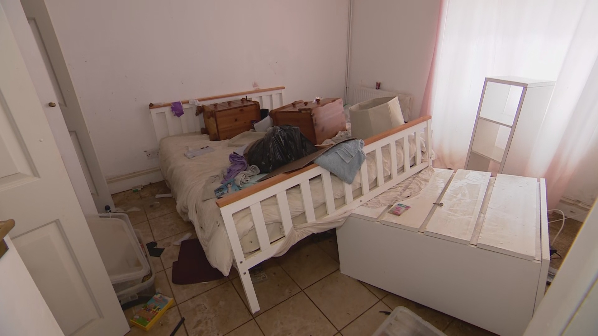 Floating beds and upturned sofas woman walks through Isle of Wight